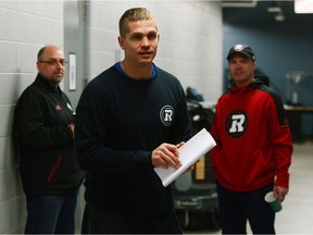 Redblacks general manager Marcel Desjardins, left, and head coach Rick Campbell, right, look towards quarterback Trevor Harris as they wait to take part in an end of season media availability on Nov. 14. THE CANADIAN PRESS/Sean Kilpatrick
