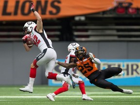 Ottawa Redblacks' Greg Ellingson, left, and B.C. Lions' Ronnie Yell (25) collide during the first half of a CFL football game in Vancouver, B.C., on Saturday, October 7, 2017.