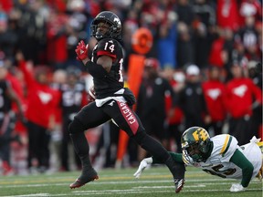 Eskimos defensive back Forrest Hightower, right, fails in his diving attempt to trip up the Stampeders' Roy Finch as he runs for a touchdown in the second half of Sunday's game. THE CANADIAN PRESS/Todd Korol