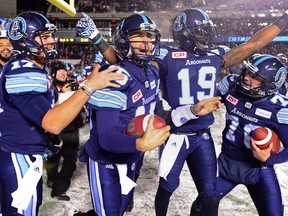 Toronto Argonauts quarterback Ricky Ray, second from left, celebrates with teammates after defeating the Calgary Stampeders in CFL football action in the 105th Grey Cup on Sunday, November 26, 2017 in Ottawa.
