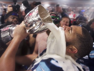 Toronto Argonauts offensive lineman Tyler Holmes celebrates with the Grey Cup in the locker room after defeating the Calgary Stampeders in the 105th Grey Cup on Sunday, November 26, 2017 in Ottawa.