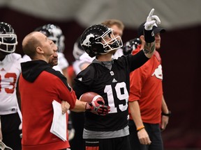 Calgary Stampeders head coach Dave Dickenson and Bo Levi Mitchell take part in the Grey Cup West Division champions practice in Ottawa on Wednesday. THE CANADIAN PRESS/Sean Kilpatrick