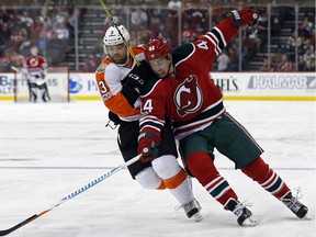 Flyers defenceman Radko Gudas, left, battles New Jersey Devils forward Miles Wood for position during a game last season. AP Photo/Adam Hunger