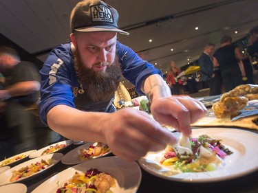 Chef Jeff Bradfield of Bar Lupulus prepares this Smoked Sturgeon with Caviar, Pickles, Crema and Shungiku as the annual Gold Medal Plates, which challenged ten different area chefs to prepare a winning recipe, took place at the Shaw Centre.  Photo Wayne Cuddington/ Postmedia
Wayne Cuddington, Postmedia