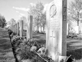 Flowers and flags grace the manicured grave of a Canadian soldier in the Groesbeek Canadian War Cemetery in the Netherlands.