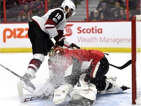 Coyotes forward Anthony Duclair scores his first goal of the game and gives Senators netminder Mike Condon something of an ice shower late in the first period of Saturday's game. THE CANADIAN PRESS/Justin Tang