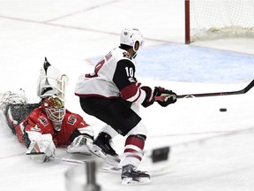 Coyotes forward Anthony Duclair chases after the loose puck after it eludes a diving poke by Senators netminder Mike Condon. Duclair tapped the puck into the net to tie the score 2-2 in the third period. THE CANADIAN PRESS/Justin Tang