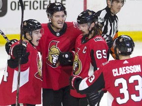 Mark Stone, second from left, celebrates with teammates after scoring the Senators' first goal against the Red Wings on Thursday night. THE CANADIAN PRESS/Adrian Wyld