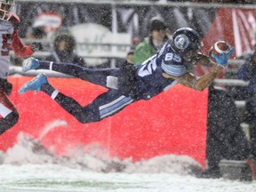 DeVier Posey of the Argonauts jumps for a touchdown against the Stampeders in the 105th Grey Cup in Ottawa on Sunday evening. Jean Levac/Postmedia