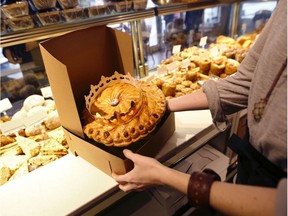 A King cake is boxed for sale in a bakery.