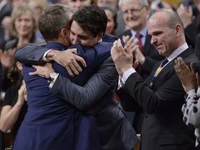 Prime Minister Justin Trudeau hugs Veteran's Affairs Minister Seamus O'Regan after making a formal apology to individuals harmed by federal legislation, policies, and practices that led to the oppression of and discrimination against LGBTQ2 people in Canada, in the House of Commons in Ottawa, Tuesday, Nov.28, 2017. THE CANADIAN PRESS/Adrian Wyld ORG XMIT: AJW211
Adrian Wyld,