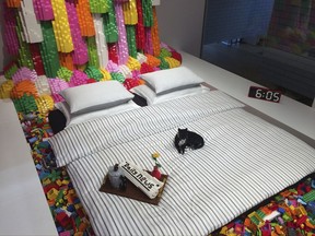 The adult's bedroom with cat and newspaper all made of Lego bricks inside the new Lego sleepover house teamed up with Airbnb, in Billund, Denmark, in this photo dated Sept. 8, 2017. Those who want to join Lego's private sleepover must enter a competition and describe what they would build if they had an infinite supply of Lego bricks, then the winner will get the chance to create their entry under expert supervision, as part of their stay at the Lego House. (AP Photo/James Brooks)