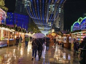 Visitors walk the grounds of the Christmas market at the Breitscheidplatz in Berlin, Monday, Nov. 27, 2017. (Gregor Fischer/dpa via AP)