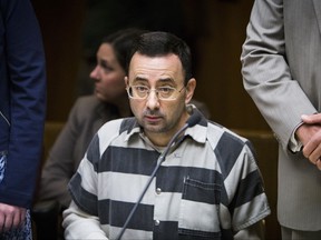 This photo taken May 12, 2017, shows Dr. Larry Nassar listening during a preliminary hearing in Mason, Mich. A person with knowledge of the agreement says the former Michigan State University and USA Gymnastics doctor will plead guilty to multiple charges of sexual assault and face at least 25 years in prison. . (Matthew Dae Smith/Lansing State Journal via AP)