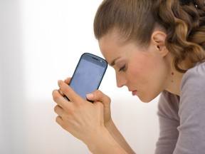 (Fotolia)  Portrait of stressed young woman with cell phone