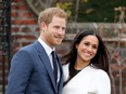 Prince Harry and Meghan Markle during an official photocall to announce their engagement at The Sunken Gardens at Kensington Palace on November 27, 2017 in London, England.