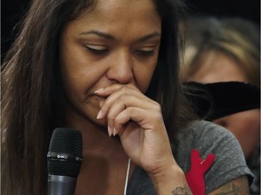 Isabel Daniels weeps as she speaks of her murdered cousin Nicole Daniels to commissioner Michelle Audette at the opening day of hearings at the National Inquiry into Missing and Murdered Indigenous Women and Girls in Winnipeg, Monday, October 16, 2017. THE CANADIAN PRESS/John Woods ORG XMIT: JGW115

CORRECTED VERSION
JOHN WOODS,