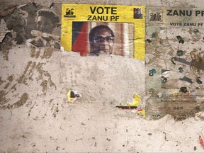 Part of an election poster from the 2008 Zanu Pf election campaign is seen the wall of a dilapidated building in the Mbara suburb of Harare, Friday Nov. 17, 2017. State broadcaster ZBC -- for decades, a mouthpiece for the Robert Mugabe government -- reported on the surging campaign for his ouster and showed video of ruling party members saying he should resign. (AP Photo)