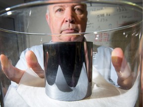 Dr Barry Wood with the half kilogram NRC3, one of six silicon weights the NRC has used to develop a refined value of Planck's constant. It's a step toward redefining the kilogram which currently is defined by a hunk of platinum more than a century old tucked away in a secure vault in Paris.