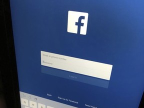 This Monday, June 19, 2017, photo shows a user signing in to Facebook on an iPad, in North Andover, Mass. Facebook says it will show users if they followed or "liked" Russia propaganda accounts on its service or on Instagram. The company said Wednesday, Nov. 22, 2017, it will launch a portal to let people see which accounts of the Internet Research Agency they followed between January 2015 and August 2017, when the pages were shut down. (AP Photo/Elise Amendola)