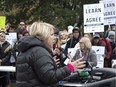 Ontario's Advanced Education Minister Deb Matthews addresses students gathered outside the Ontario Legislature in Toronto on Nov. 1 as they protest against the ongoing strike by Ontario faculty members.