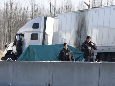 OPP investigate an accident on Highway 401 just east of Prescott Ontario Tuesday Nov 28, 2017. A Quebec trucker was arrested early Tuesday morning hours after two people were killed in a five-vehicle crash late Monday on Highway 401. Four people were also taken to hospital after the crash at about 10:30 p.m. Monday between Prescott and Highway 416, one of them by air ambulance with life-threatening injuries.