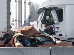 Two people are dead and a man has been arrested following a multi-vehicle crash on Highway 401 near Prescott.