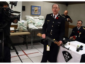 Drugs and guns

OPP Chief Superintendent John Sullivan of the OPP Organized Crime Enforcement Bureau handles a seized firearm as Chief Inspector Marc Leduc of Gatineau Police Criminal Investigations, right, looks on during a news conference in Ottawa on Tuesday, November 8, 2017. Police raided several location in the Ottawa and Gatineau area on Monday. THE CANADIAN PRESS/Fred Chartrand ORG XMIT: FXC102
FRED CHARTRAND,