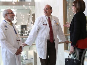 Dr. Harry Atkins, Dr. Mark Freedman and Jennifer Molson chat at General campus of The Ottawa Hospital.