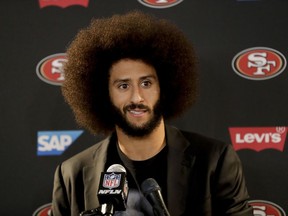 FILE - In this Dec. 24, 2016, file photo San Francisco 49ers quarterback Colin Kaepernick talks during a news conference after an NFL football game against the Los Angeles Rams. The free agent quarterback was named GQ magazine's "Citizen of the Year" for his activism on Nov. 13, 2017. (AP Photo/Rick Scuteri, File)