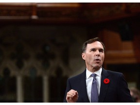 Minister of Finance Bill Morneau stands during question period in the House of Commons on Parliament Hill in Ottawa on Thursday, Nov. 2, 2017. Parliament's spending watchdog says Liberal changes to passive investments rules for small businesses could rake in up to $6 billion annually in new tax revenues after the next decade.