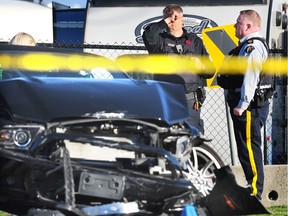 Police and officers from the Independent Investigations Office (IIO) on scene after an Abbotsford police officer was fatally shot on Mt. Lehman Road near the Fraser Highway in Abbotsford, B.C., on Nov. 6, 2017.