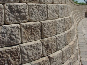 Textured surfaces and attractive colours let concrete blocks work as stand-alone building elements. This retaining wall combines good looks with ease of construction.