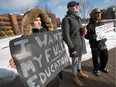 Algonquin College students (from left) Serene Deir, Keenan Smith-Soro and Shane Plumb-Saumure, protest at the entrance Algonquin's Woodroffe campus on Monday.