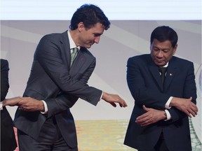 Justin Trudeau Nguyen Xuan Phuc  Nguyen Xuan Phuc

Canadian Prime Minister Justin Trudeau shakes hands with Vietnamese Prime Minister Nguyen Xuan Phuc and Philippine President Rodrigo Duterte during a photo for the ASEAN-Canada 40th Commemorative session in Manila, Philippines, Tuesday, November 14, 2017. THE CANADIAN PRESS/Adrian Wyld ORG XMIT: ajw105
Adrian Wyld,