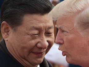 China's President Xi Jinping and US President Donald Trump attend a welcome ceremony at the Great Hall of the People in Beijing on November 9, 2017.
