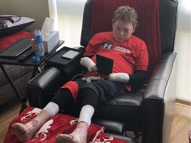 Jonathan Pitre reading on his iPad while back in his apartment on Wednesday.