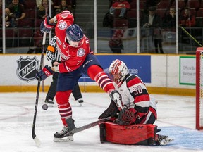 67's netminder Olivier Tremblay (30) fights to see the puck through a screen by the Generals' Hayden McCool (7) during the third period of Friday's game. Valerie Wutti photo.