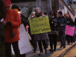 Dozens of people gathered at the Women's Monument in Minto Park to march with candles and handmade signs to city hall as part of the UNiTE Campaign and the 16 Days Canada Campaign to End Violence against Women and Girls, on Nov. 25, 2017. David Kawai/Postmedia