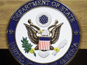 FILE - This Jan. 25, 2010, file photo, shows the United States Department of State seal on a podium at the State Department in Washington. America's registered child sex offenders will now have to use passports identifying them for their past crimes when traveling overseas. The State Department said Wednesday it would begin revoking passports of registered child sex offenders and requiring them to apply for a new one that carries a "unique identifier" of their status. (AP Photo/Alex Brandon, File)