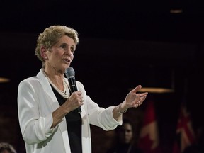 Premier Kathleen Wynne addresses questions from the public during a town hall meeting in Toronto on Monday, November 20, 2017. Ontario recently changed its minimum wage, sparking a major debate about the policy's virtues.
