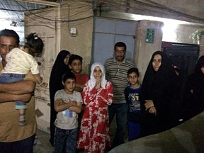 People stand in the street after feeling aftershocks from an earthquake in Baghdad, Iraq, Sunday, Nov. 12, 2017. The deadly earthquake hit the region along the border between Iran and Iraq on Sunday. The U.S. Geological Survey said the quake was centered 19 miles (31 kilometers) outside the eastern Iraqi city of Halabja. (AP Photo/Hadi Mizban)