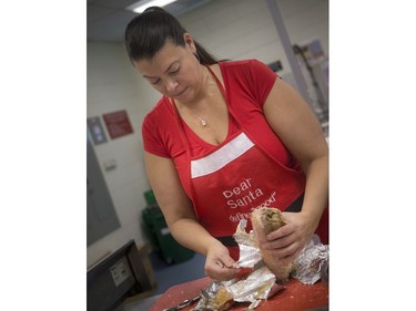Volunteers, students and chefs were busy preparing a festive meal in support of Operation Big Turkey at the Algonquin College School of Hospitality Kitchen Saturday December 23, 2017. The thirteenth year of Operation Big Turkey has over 200 volunteers coming together to make 2500 turkey dinners to anyone who would like to have a meal.  Vanessa Simmons was working on the turkey, getting it prepared for dinners.   Ashley Fraser/Postmedia