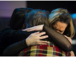 Colleen Noble (right) hugs a member of the congregation.