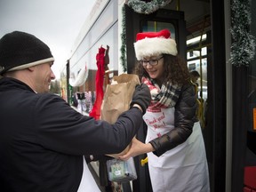 Volunteers Matt Abbott and Shaen Ferguson load a bus at the Real Canadian Superstore in Westboro.
