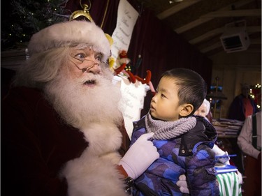 Santa had a big chat with three and a half-year-old Mark Lu on Saturday.  Ashley Fraser/Postmedia