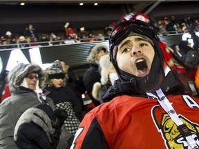 Fans react to the Ottawa Senators scoring against the Montreal Canadiens during the NHL 100 Classic in Ottawa on Saturday, Dec. 16, 2017 at TD Place.