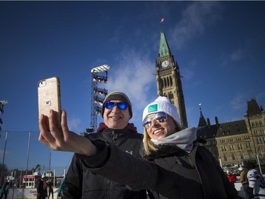 Jennifer Morand and Jeff Condie took a selfie with the Peace Tower in the back ground as they were out for a skate. People braved the chilly temperatures to enjoy a skate in the sunshine on Parliament Hill, part of the Canada 150 events on Parliament Hill Saturday December 16, 2017.