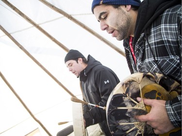 L-r singers Yancey Thusky of Barriere Lake and Awema Tendesi of Kitigan Zibi led "Tewehgan" hand drum lessons in a tipi, part of the Canada 150 events on Parliament Hill Saturday December 16, 2017.