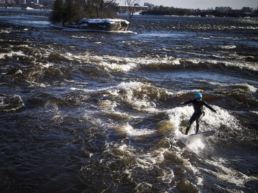 David Alicandro didn't let a little cold weather stop him from getting out for a surf Saturday December 16, 2017 on the Ottawa River.